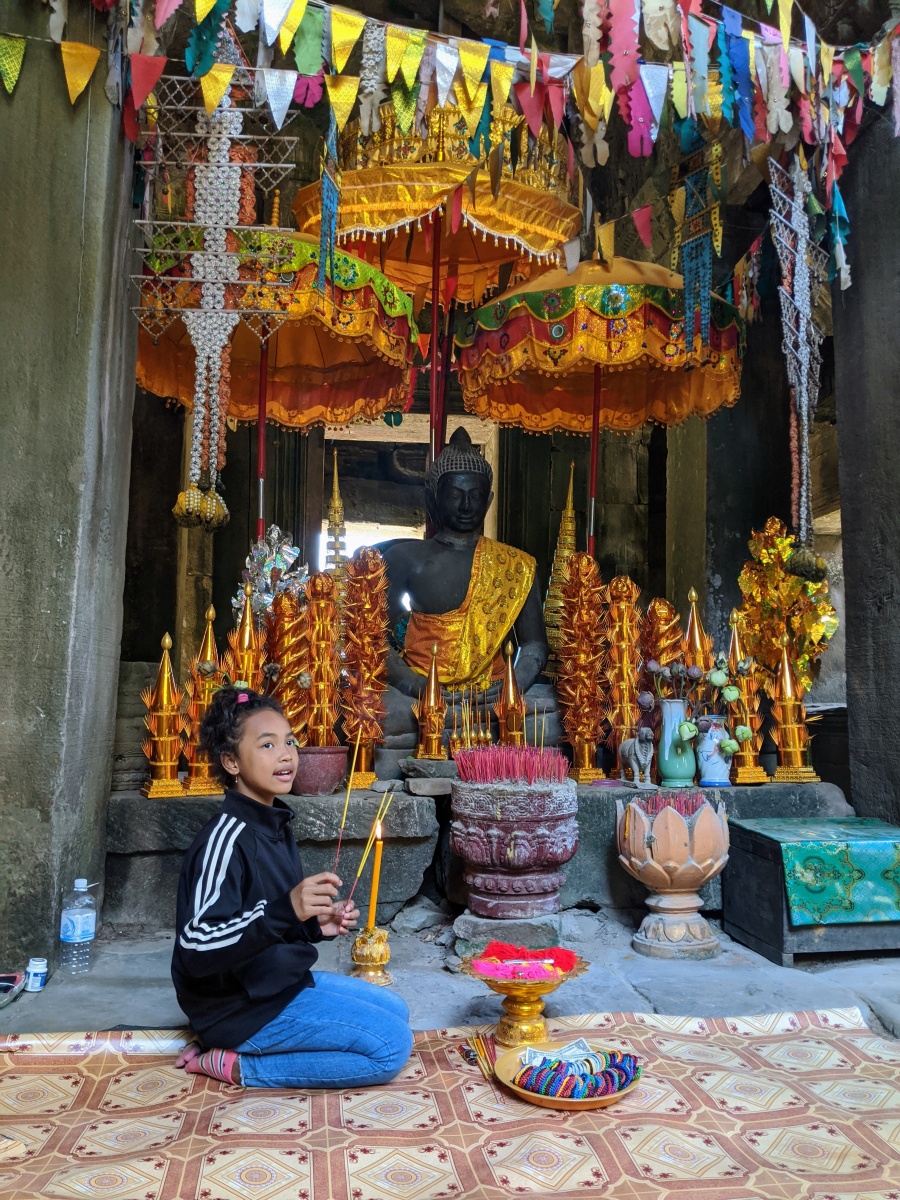 Girl selling incense in a temple in Angkor